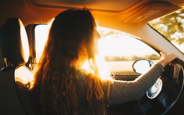 Woman driving sunny car