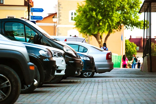 Line of parked cars A line of cars parked up in a cobbled car park