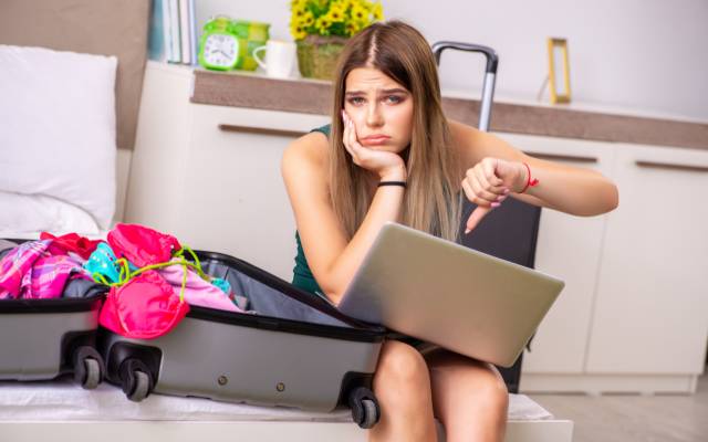 Young woman upset at having to cancel her holiday Young woman upset at having to cancel her holiday